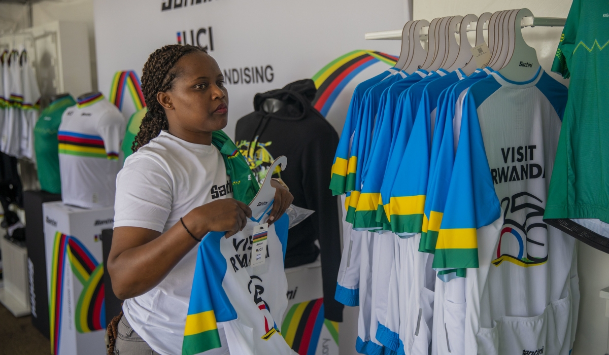 A businesswoman sells different items including cycling jerseys among others at Kigali Heights fan zone on Saturday, September 21. Craish Bahizi