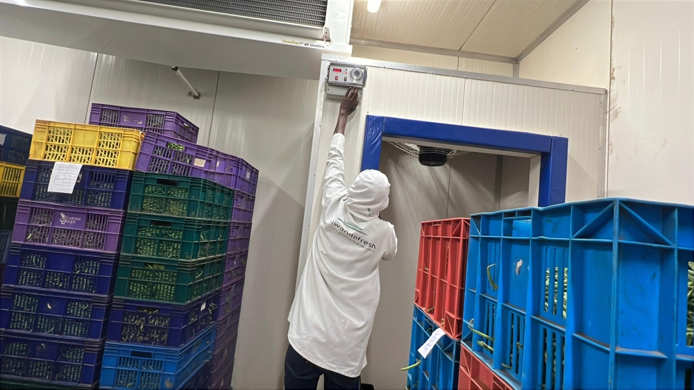 A worker setting a temperature inside a cooling room at Kigali Special Economic Zone. Courtesy
