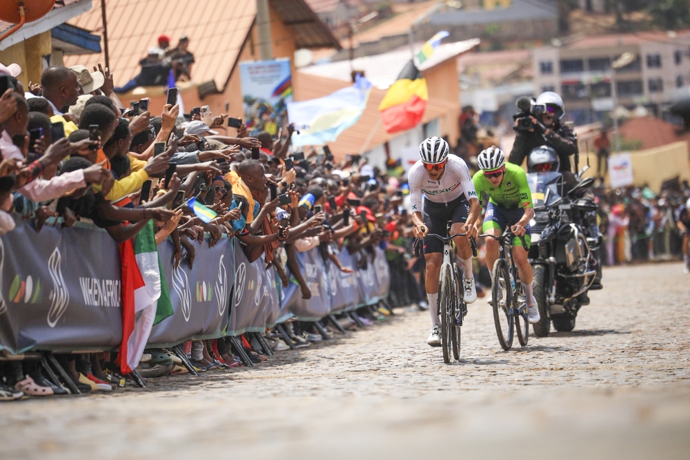 Isaac del Toro Romero (Mexico) and Slovenia’s Tadej Pogačar climb the cobbled street of Mur de Kigali in Nyarugenge on Sunday. Photo by Olivier Mugwiza