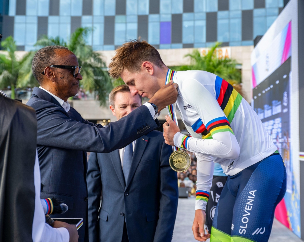 President Paul Kagame, alongside UCI President David Lappartient, awards Slovenian cyclist Tadej Pogačar after his victory at the 2025 UCI Road World Championships in Kigali on Sunday, September 28.