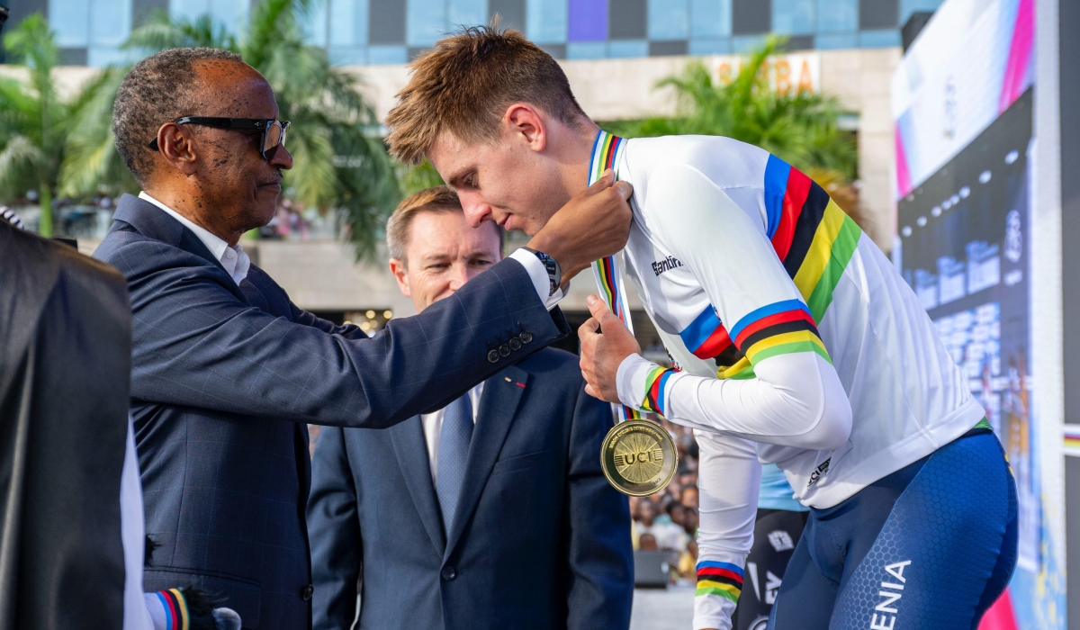 President Paul Kagame, alongside UCI President David Lappartient, awards Slovenian cyclist Tadej Pogačar after his victory at the 2025 UCI Road World Championships in Kigali on Sunday, September 28.