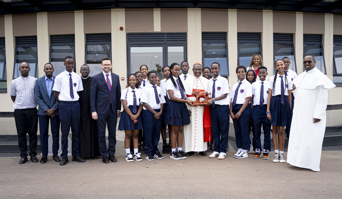 Cardinal Kambanda poses for a photo with students and officials during his visit on Wednesday. Photos by Kellya Keza