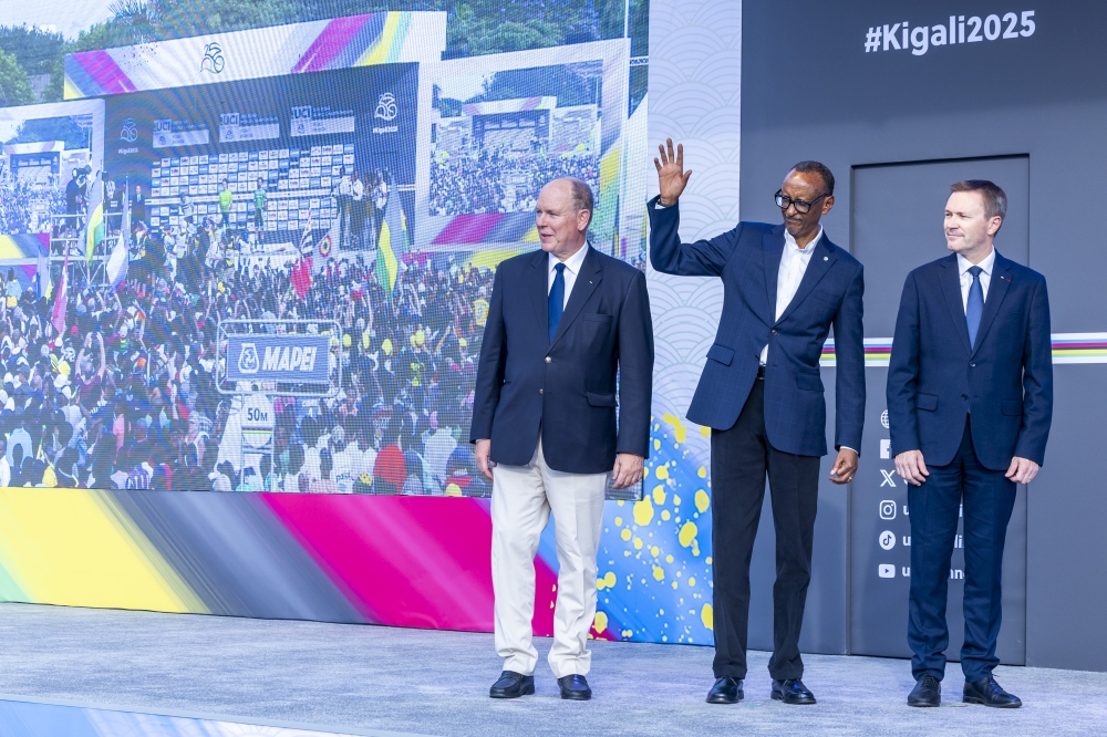 President Paul Kagame waves to the crowd at KCC Roundabout in Kigali on Sunday, September 28, with UCI President David Lappartient and Prince Albert II of Monaco. Photo by Olivier Mugwiza