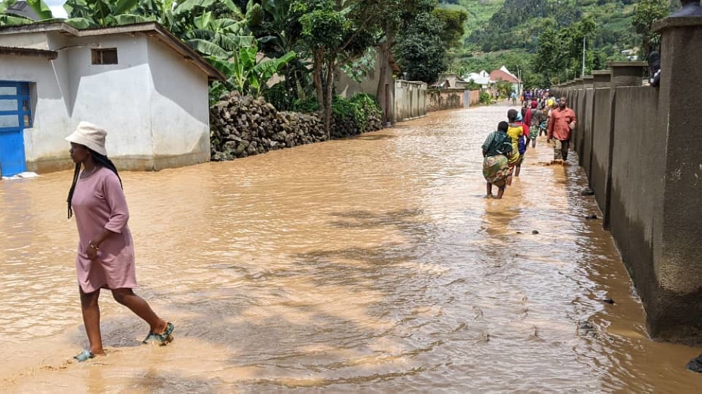 Residents wade through a flooded residential area in Rubavu on May 3, 2023.  Germain Nsanzimana