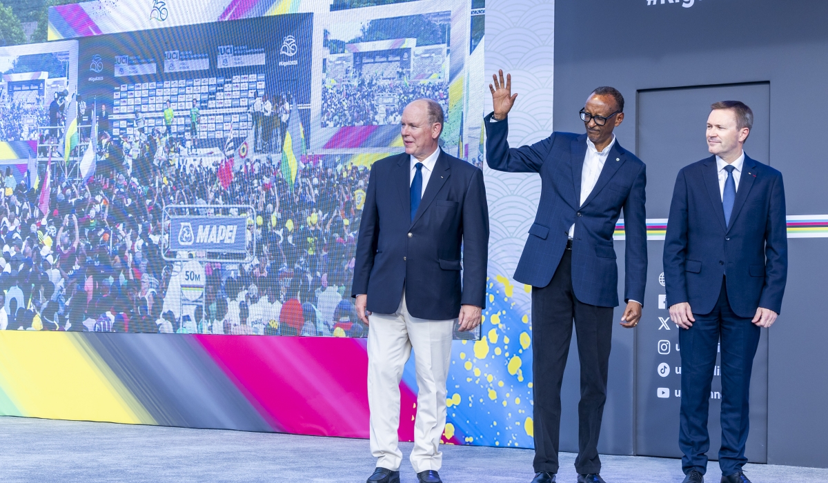 President Paul Kagame waves to the crowd at KCC Roundabout in Kigali on Sunday, September 28, with UCI President David Lappartient and Prince Albert II of Monaco. Photo by Olivier Mugwiza
