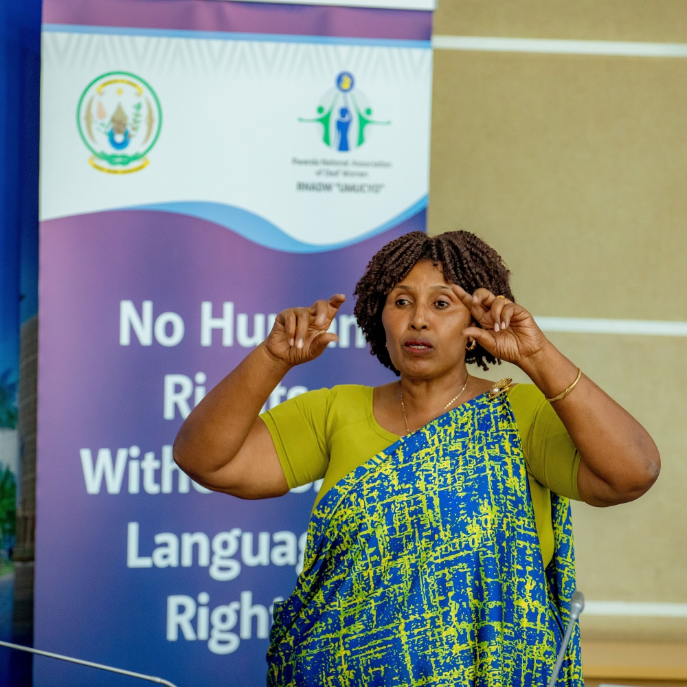 Pelagie Muhorakeye, President of RNADW, using sign language to communicate during the event. Courtesy.