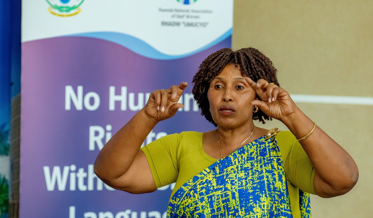 Pelagie Muhorakeye, President of RNADW, using sign language to communicate during the event. Courtesy.