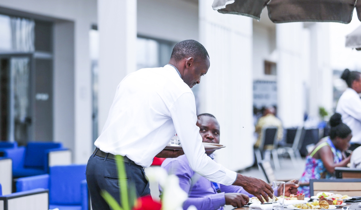 A waiter serves a customer at a hotel in Kigali. Sam Ngendahimana