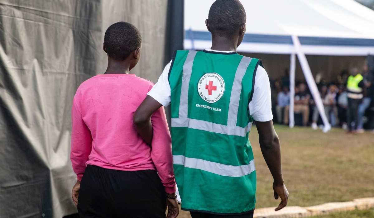 A volunteer helps a trauma victim during a commemoration event at Kicukiro Nyanza Genocide Memorial on April 11. Photo by Dan GATSINZI