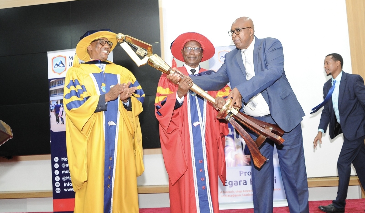 Prof. Simon Gicharu (right) hands over the Mace, one of the instruments of authority, to Prof. Egara Kabaji. Looking on is Dr Innocent Mugisha (left) Chairman , University Governing Body.