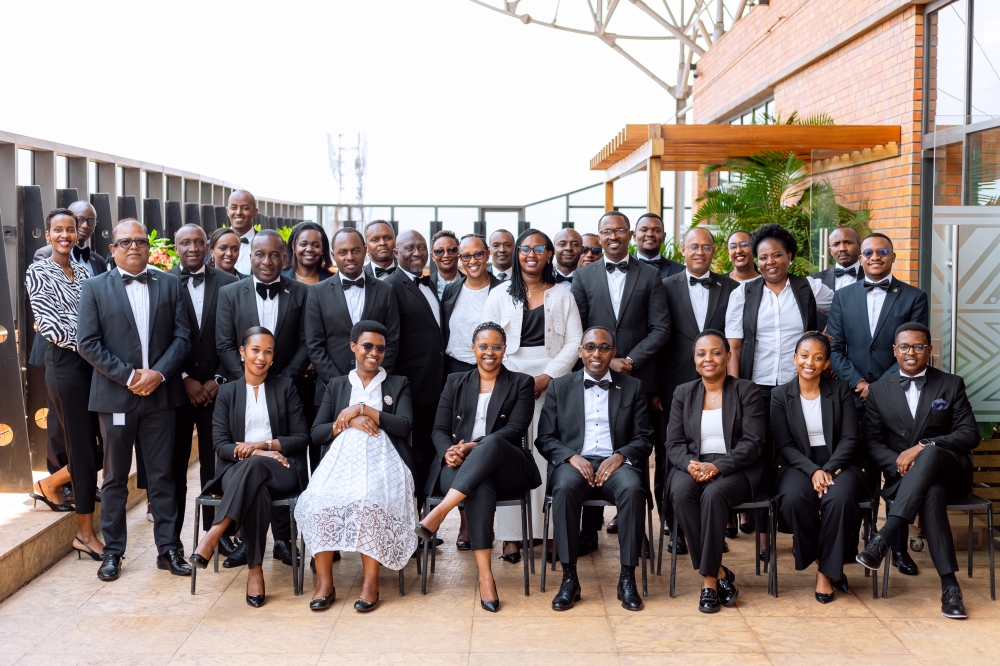 I&M Bank Rwanda officials and staff pose for a group photo.