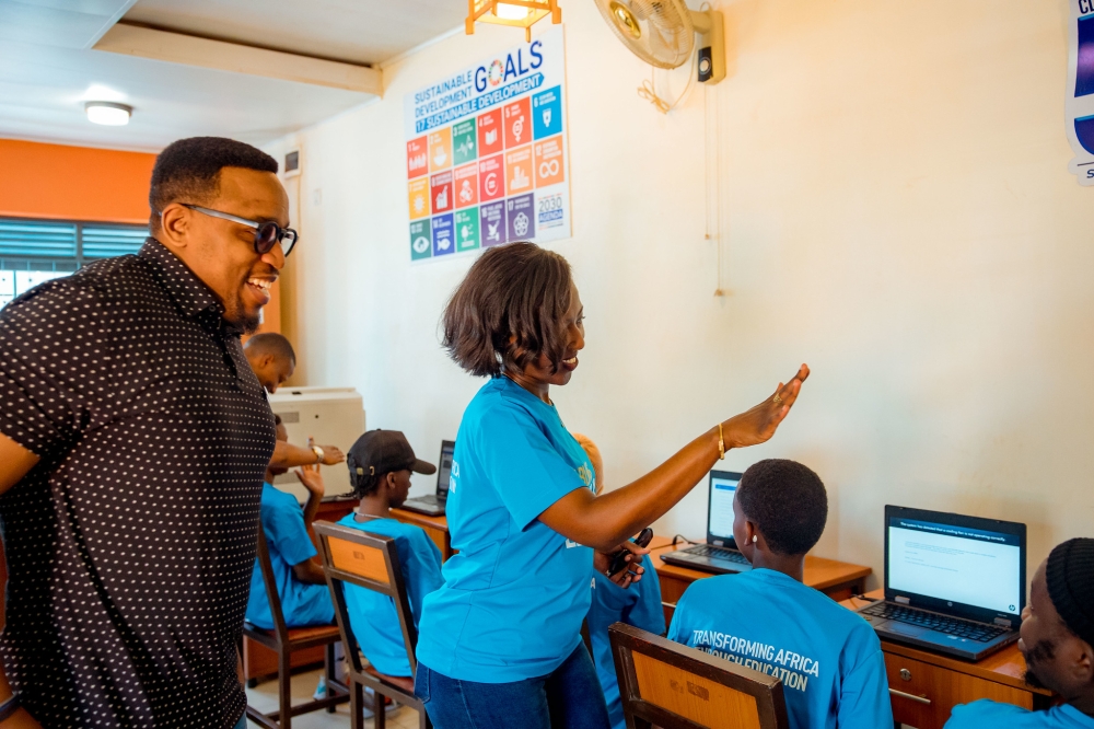 Olivier Brave Ngabo, Permanent Secretary at the Ministry of Youth and Arts and Carine Umutoni, Ecobank Rwanda Managing Director speak to youths as  Ecobank Rwanda donated computers to youth centres under the Ministry of Youth and Arts. All photos by Kellya Keza