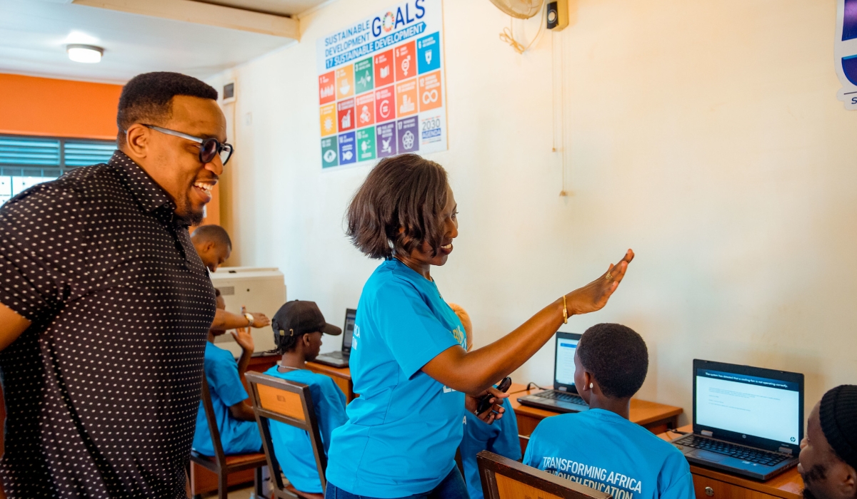 Olivier Brave Ngabo, Permanent Secretary at the Ministry of Youth and Arts and Carine Umutoni, Ecobank Rwanda Managing Director speak to youths as  Ecobank Rwanda donated computers to youth centres under the Ministry of Youth and Arts. All photos by Kellya Keza