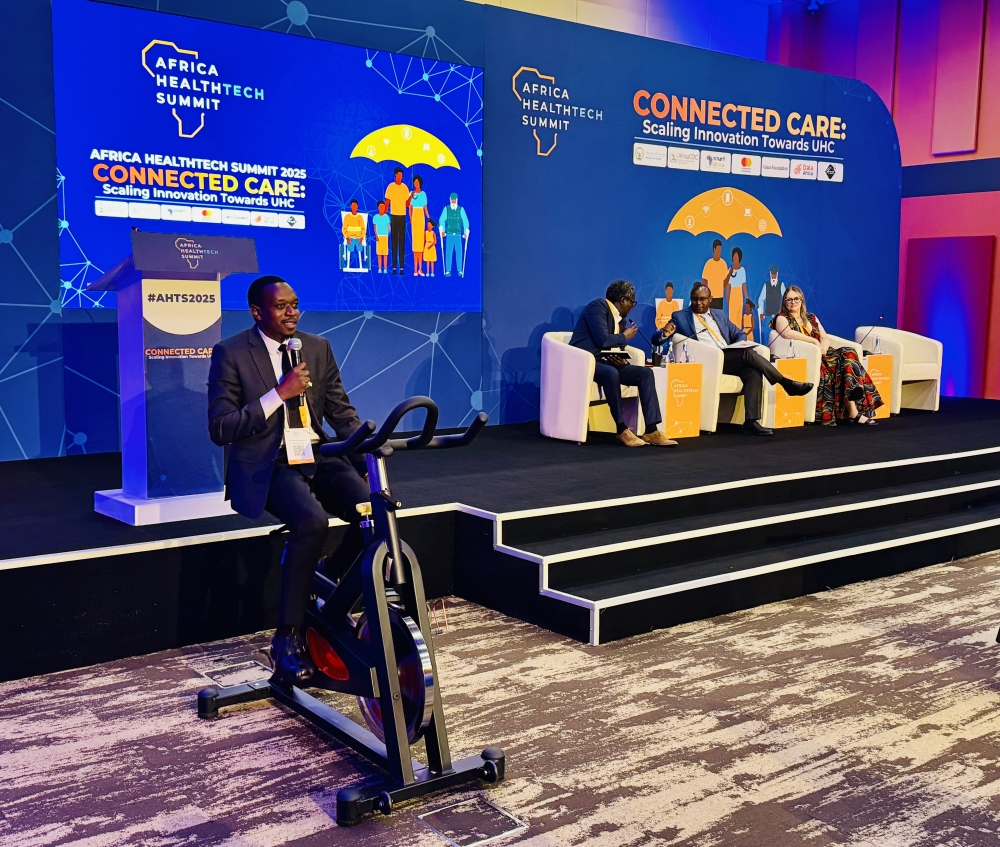 Rwanda NCD Alliance Executive Director, Alphonse Mbarushimana, riding an exercise bicycle for demonstration in line with be healthy be mobile theme at the Africa Health Tech Summit in Kigali, on October 13, 2025 (Emmanuel Ntirenganya).