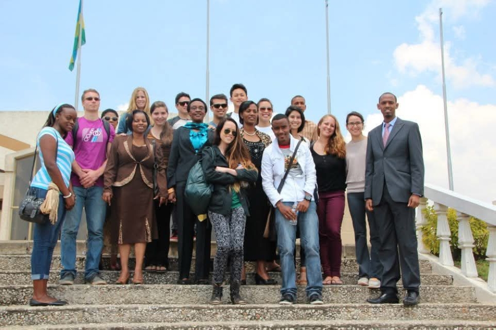 Late Marie Immaculée Ingabire (3rd left, second row) poses for a photo with US based students accompanied with Jean Pierre Karegeye, the author,  during their visit in Rwanda. Photographed here at the parliament building in Kigali. Photo: Courtesy.