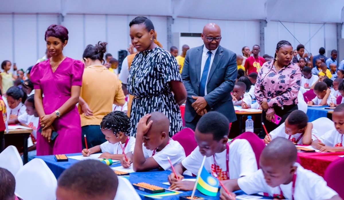 State Minister for Education Claudette Irere and Rwanda Education Board Nelson Mbarushimana visit children during Shenmo Africa Cup Abacus Mental Math Olympiad in Kigali on Saturday. Courtesy