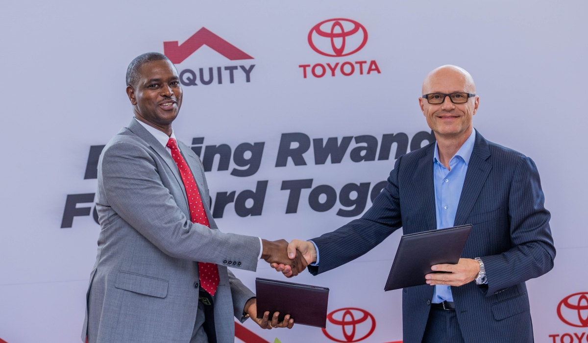 Eric Rutabana, Equity Bank Rwanda’s Commercial Director, and Nenad Predrevac, Managing Director of Toyota Rwanda Ltd sign the agreement in Kigali on Monday, October 20. All photos by Craish BAHIZI