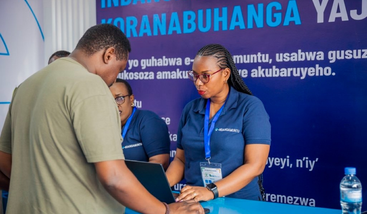 NIDA staff speaks to people about the upcoming e-indangamuntu at Kigali Trade Fair in August. Courtesy.