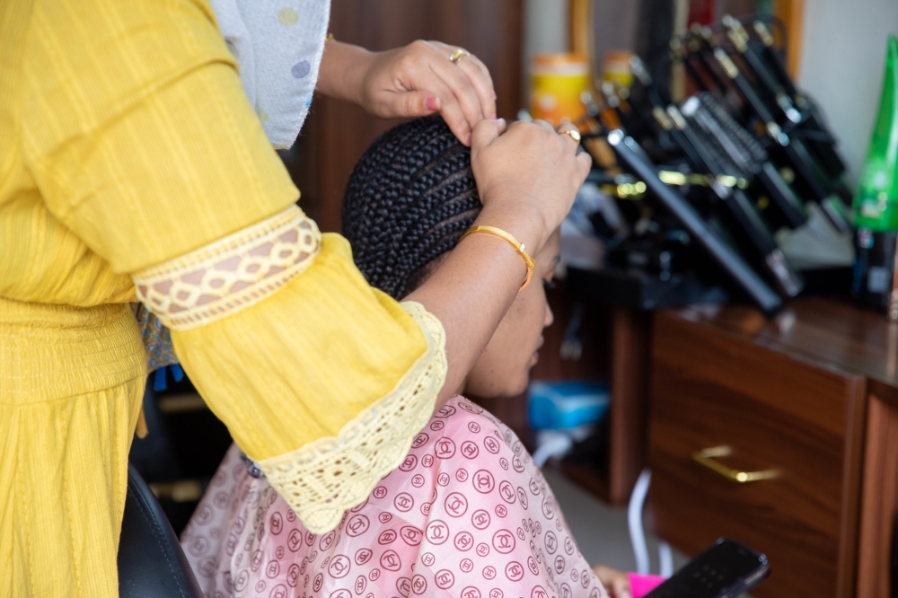 A hairdresser from Sudan who runs her business in Rwanda. Photo by Willy Mucyo
