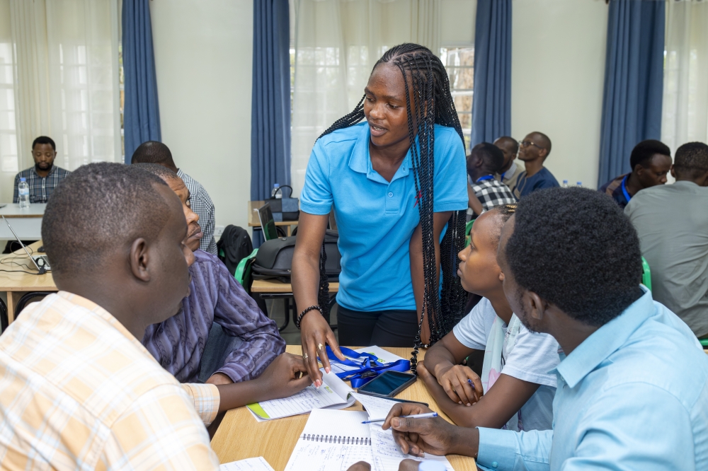 An instructor engages with participants  during a hands-on session at a Go Solar training course at ACES. Photo by  Mireille Isimbi- Clean Cooling Network.