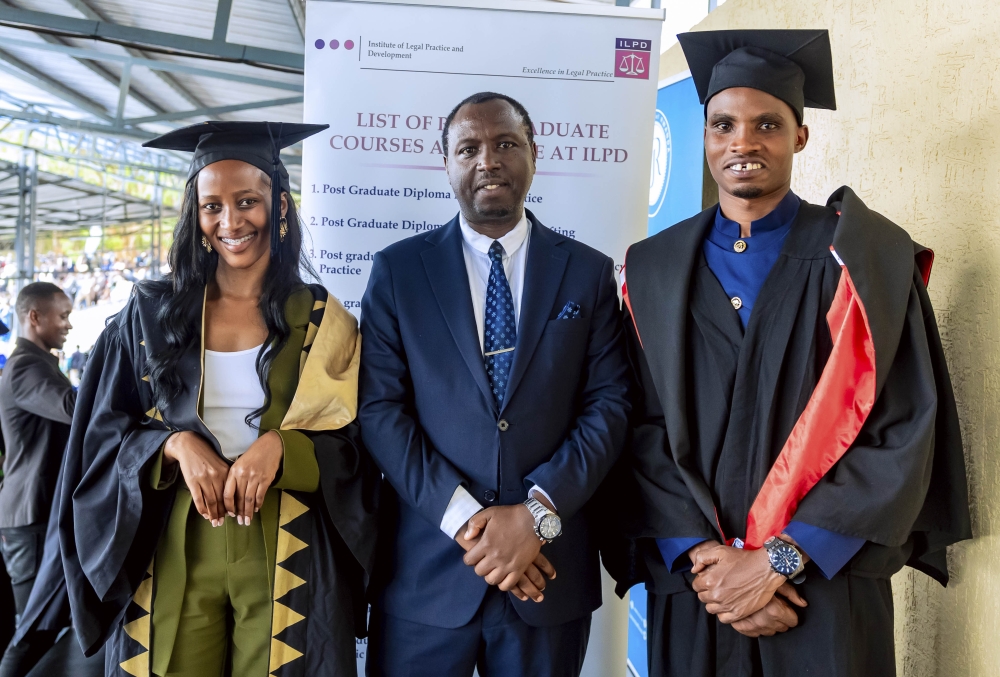 Erick Shirimpumu, Vice Rector in charge of Finance and Administration at ILPD (c) poses for a picture with Josiane Uwihirwe and Frederick Kwihangana, the top performers from University of Rwanda school of law  who received scholarships to study at ILPD. cOURTESY