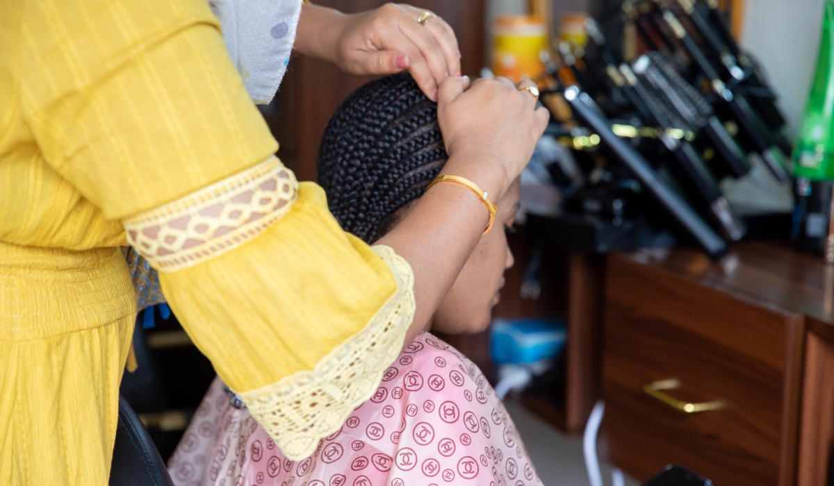A hairdresser from Sudan who runs her business in Rwanda. Photo by Willy Mucyo