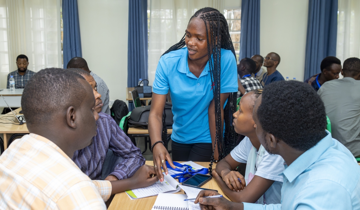 An instructor engages with participants  during a hands-on session at a Go Solar training course at ACES. Photo by  Mireille Isimbi- Clean Cooling Network.