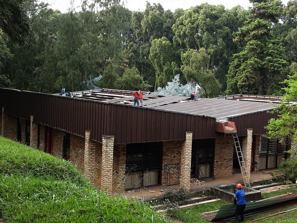 Workers remove asbestos on the roof of one of buildings of University of Rwanda in Huye. File