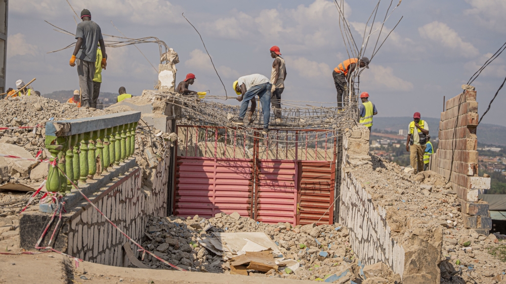 Workers on duty during demolition works to pave the way for the expansion of the Giporoso–Masaka road. Photo by Kellya Keza