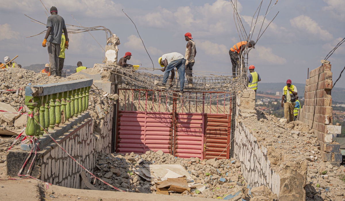 Workers on duty during demolition works to pave the way for the expansion of the Giporoso–Masaka road. Photo by Kellya Keza
