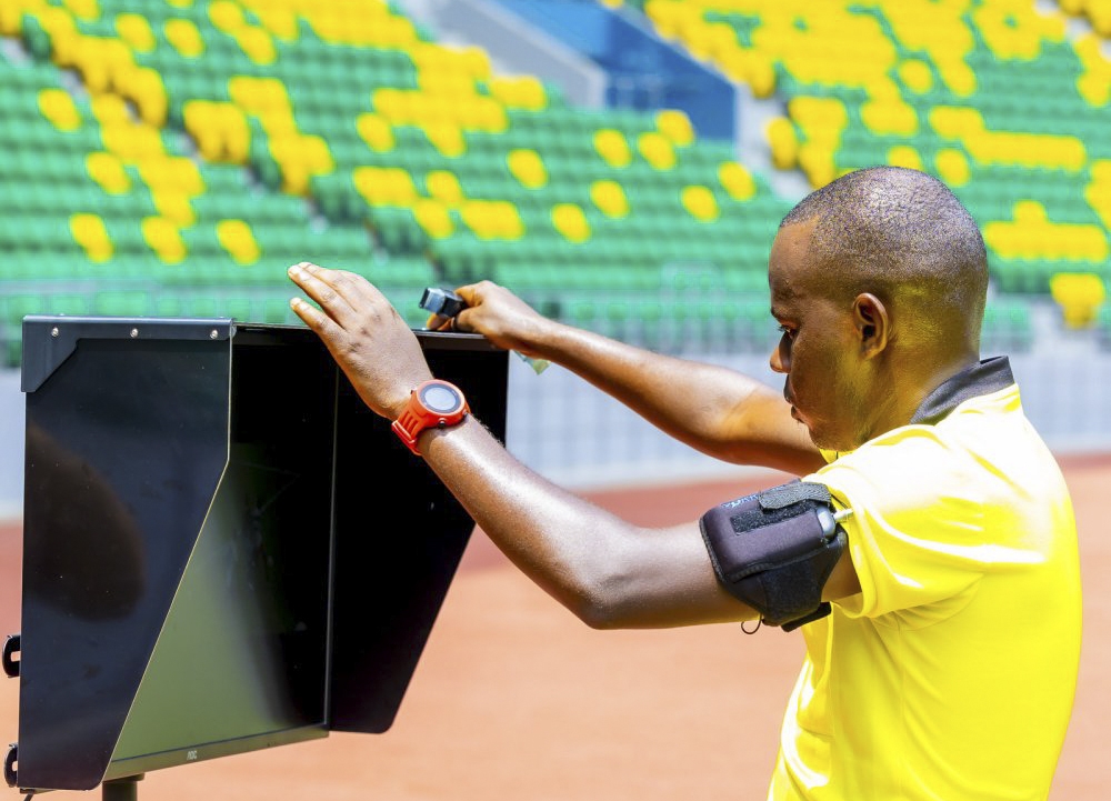 A central referee checks VAR video during an exercise of using VAR at Amahoro Stadium