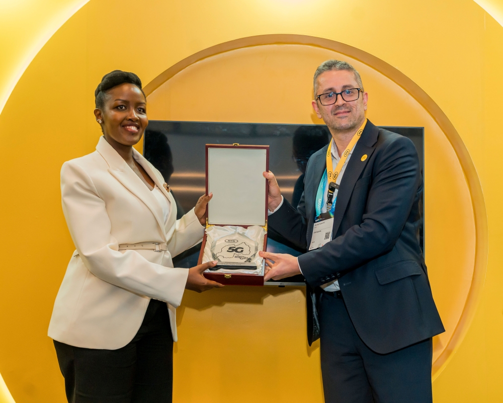 Minister of ICT and Innovation, Paula Ingabire receives a token of appreciation from MTN Rwanda CEO Monzer Ali during the Mobile World Congress Kigali 2025.