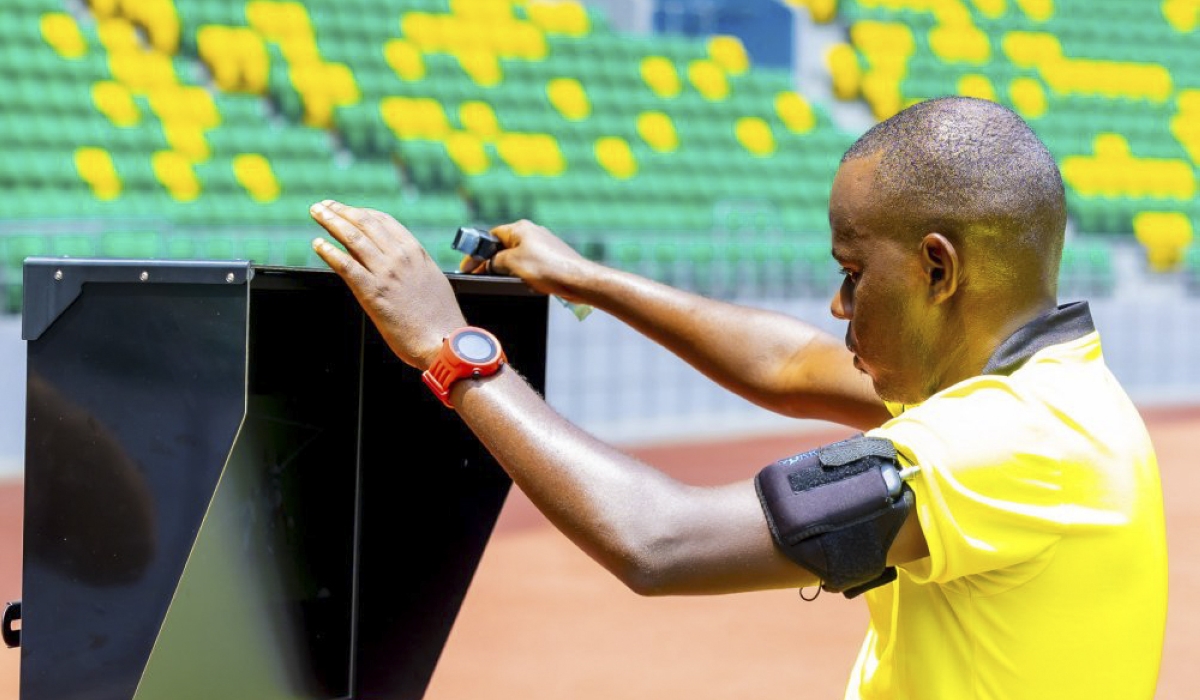 A central referee checks VAR video during an exercise of using VAR at Amahoro Stadium