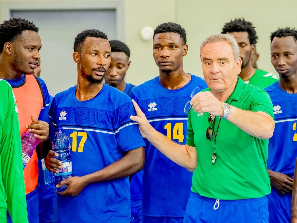 National handball team head coach, Hafedh Zouabi, interacts with a player during the training in Kigali. Courtesy 
