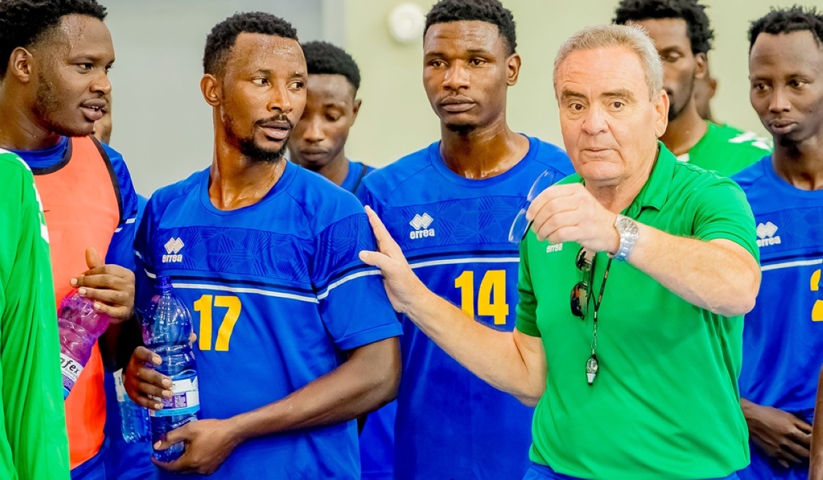 National handball team head coach, Hafedh Zouabi, interacts with a player during the training in Kigali. Courtesy 