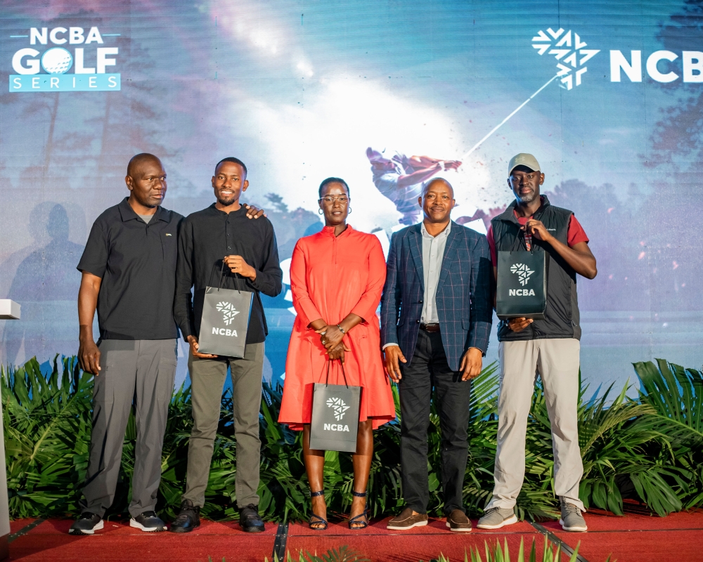 L–R: Club Captain Eugene Murenjekha, gross overall winners Benjamin Mukisa and Jenny Linda, NCBA Managing Director Maurice Toroitich, and Sanday Kabarebe, who received the prize on behalf of David Rwiyamirira, pose for a group photo.
