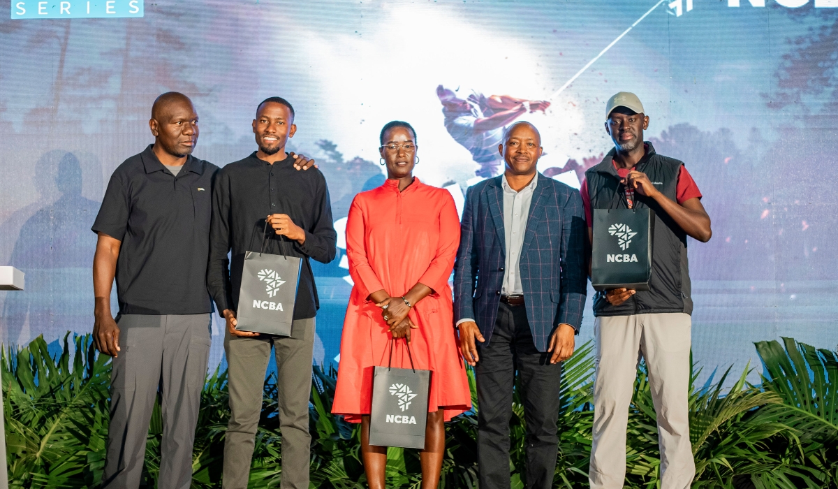 L–R: Club Captain Eugene Murenjekha, gross overall winners Benjamin Mukisa and Jenny Linda, NCBA Managing Director Maurice Toroitich, and Sanday Kabarebe, who received the prize on behalf of David Rwiyamirira, pose for a group photo.