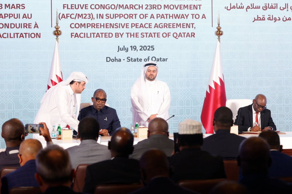 Representatives of the Congolese government and the AFCM23 movement sign the declaration of principles in Doha on July 19. File
