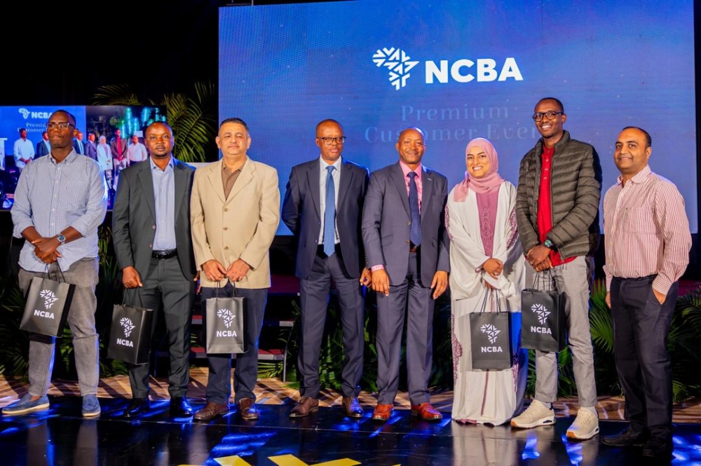 NCBA Managing Director Maurice Toroitich poses with some of the recognized customers at the event.
