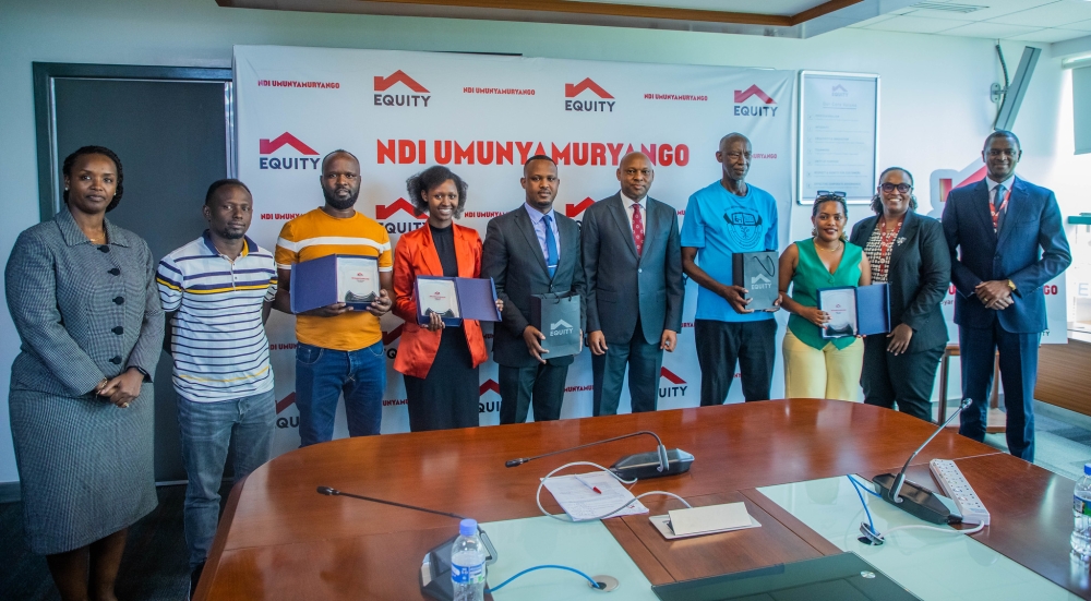 Equity Bank officials and clients pose for a group photo during the launch of the new Ndi Umunyamuryango campaign in Kigali on November 4. Photos by Craish Bahizi