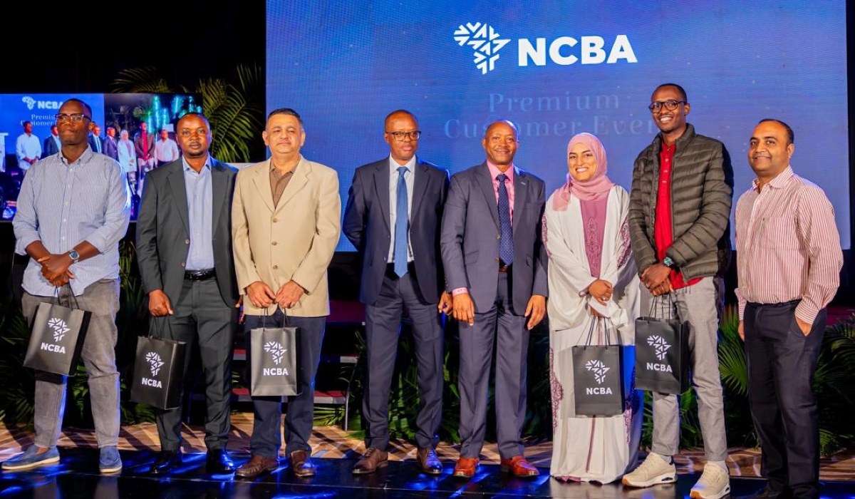 NCBA Managing Director Maurice Toroitich poses with some of the recognized customers at the event.