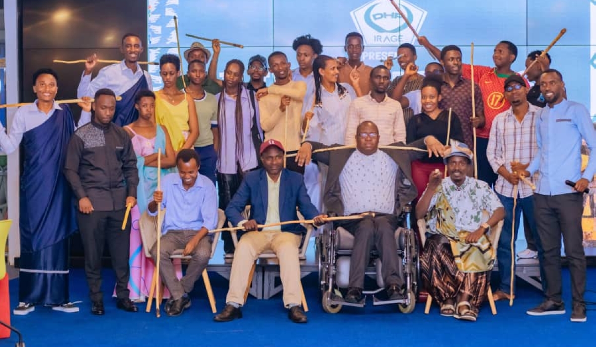 Cultural enthusiasts pose with Inkoni, traditional Rwandan walking sticks that symbolize authority, pride, and respect.