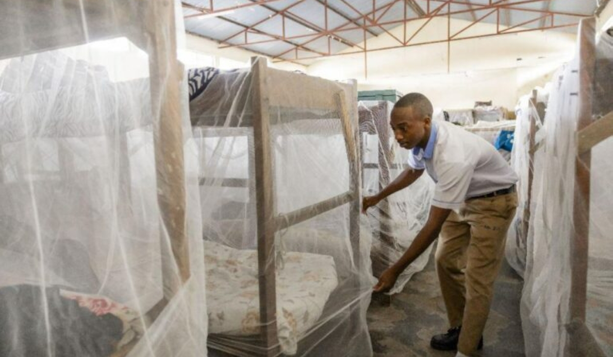 A student carefully arranges a mosquito net on his bed before heading to class. The country has recorded more than 91,000 malaria cases, with 87 percent concentrated in 15 districts. Courtesy