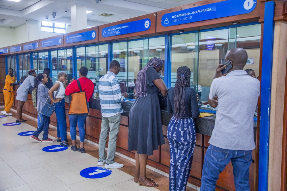 Bank of Kigali tellers attend to customers at the bank’s main branch in Kigali in October. Photo by Craish Bahizi.