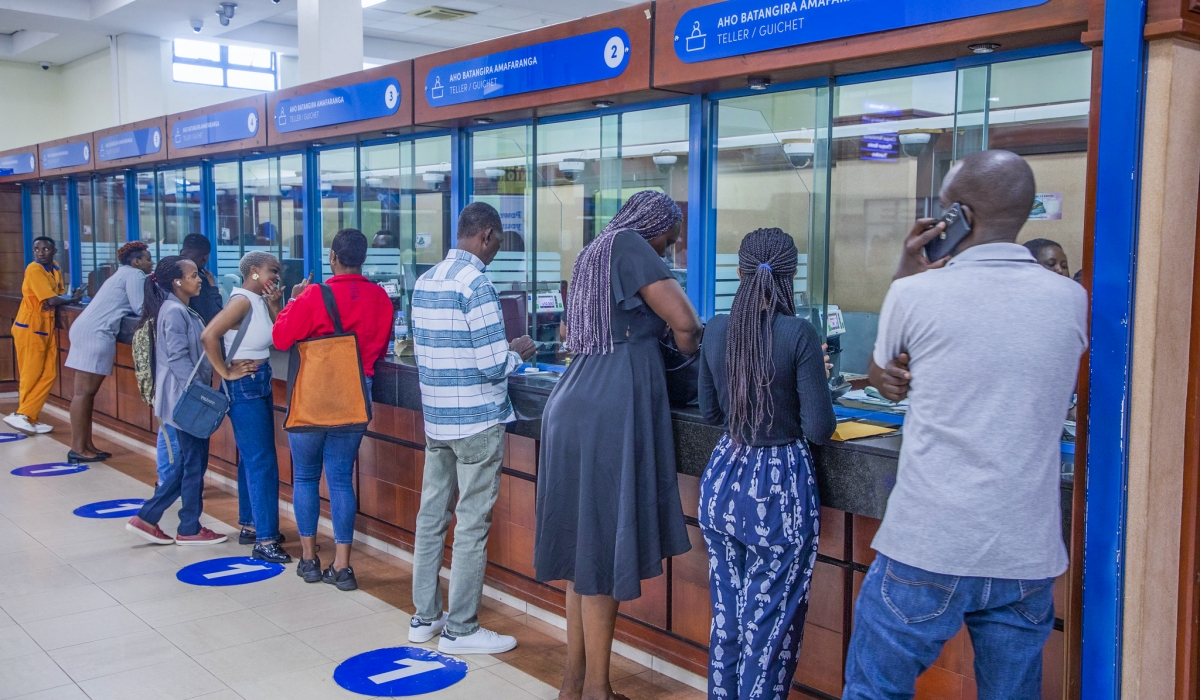 Bank of Kigali tellers attend to customers at the bank’s main branch in Kigali in October. Photo by Craish Bahizi.