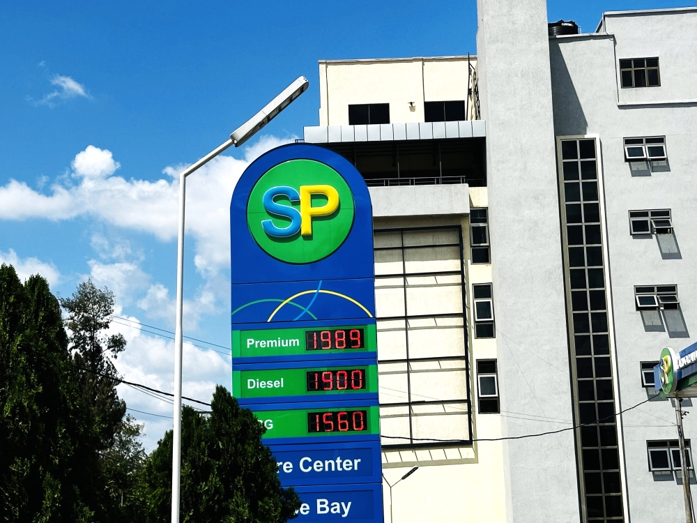 A sign post at SP Nyarutarama displays new fuel prices. Photo by Confiance Mugisha