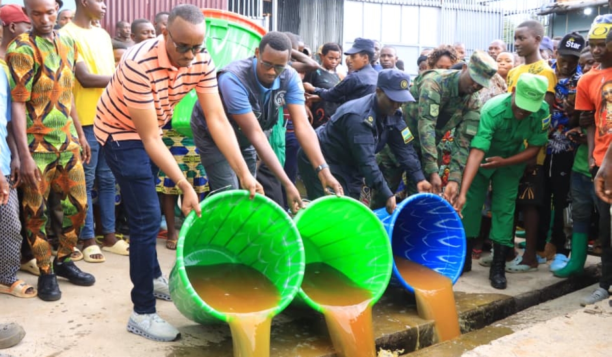 Mayor of Bugesera District, Richard Mutabazi, and security officers during a crackdown on illegal production of alcoholic drinks where they  destroyed more than 74,000 litres in one day. Courtesy