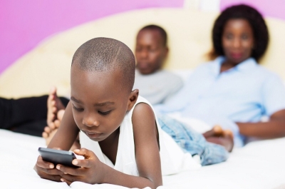 A child watches a video on a smartphone. Rwandans will join the rest of the world in celebrating World Children’s Day on November 20. Courtesy