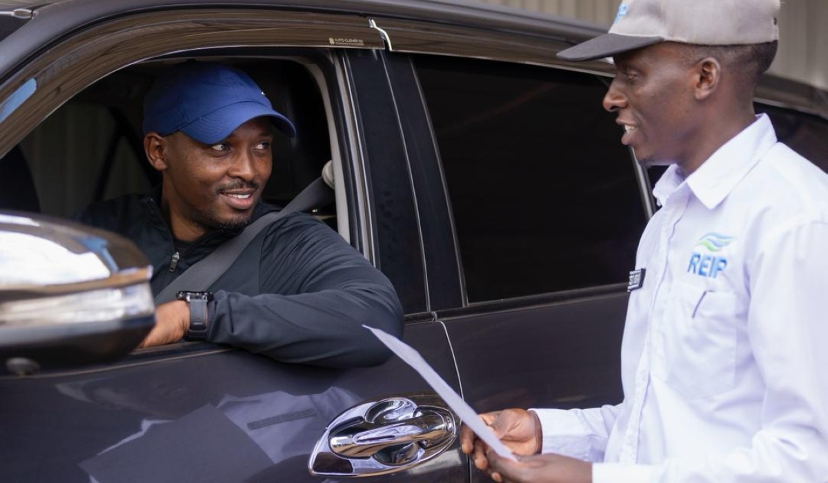Minister of Health Dr Sabin Nsanzimana speaks to an official  while  taking his own car for inspection at Ndera Automobile Inspection Centre on Saturday, November 22.