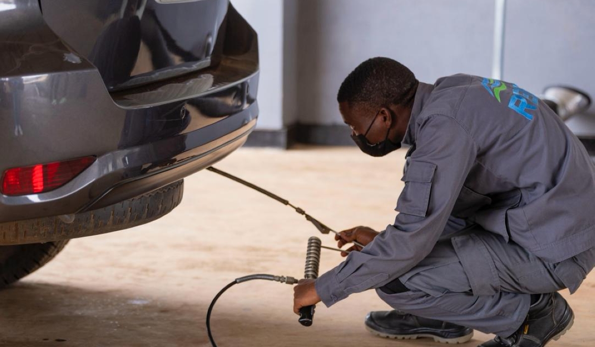 A worker conducts air pollution test at Ndera Automobile Inspection Centre on Saturday, November 22. Courtesy